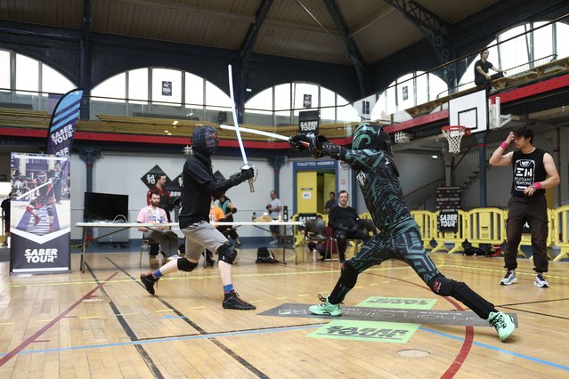 Participants fight during the 8th edition of French Lightsaber Open at the Japy Gymnasium, in Paris, on June 22, 2025. More than 80 European participants compete during at the 8th edition of French Lightsaber Open, the largest international sports lightsaber competition in the world at the Japy Gymnasium, in Paris, on June 22, 2025. (Photo by Romain Perrocheau/AFP Photo)