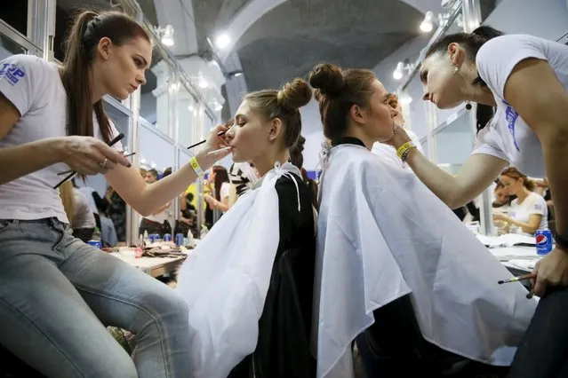 Models have their makeup done backstage at Ukrainian Fashion Week in Kiev, October 18, 2015. (Photo by Valentyn Ogirenko/Reuters)