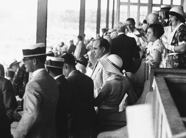 “Scarface” Al Capone, who must vacate his gangland throne for a stretch in Leavenworth, caused quite a furor among the 40,000 persons in attendance at the American Derby, Washington Park Track in Chicago, June 20, 1931. Capone is shown to the right of lady in clubhouse box, wearing light gray suit. (Photo by AP Photo)