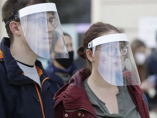 Demonstrators wear protective face masks during a protest a church where they were protesting church support for tightening Poland's already restrictive abortion law in Warsaw, Poland, Sunday, October 25, 2020. (Photo by Czarek Sokolowski/AP Photo)