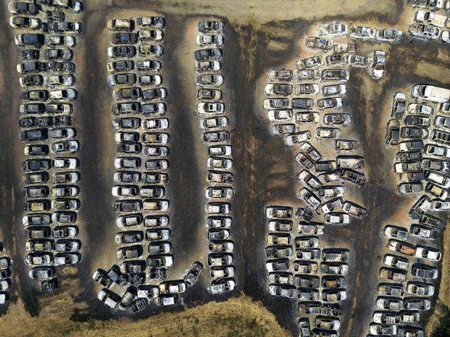 Charred vehicles damaged by wildfires sit in an impound lot in Kato Achaia, near Patras, western Greece, August 13, 2025. (Photo by Thanassis Stavrakis/AP Photo)