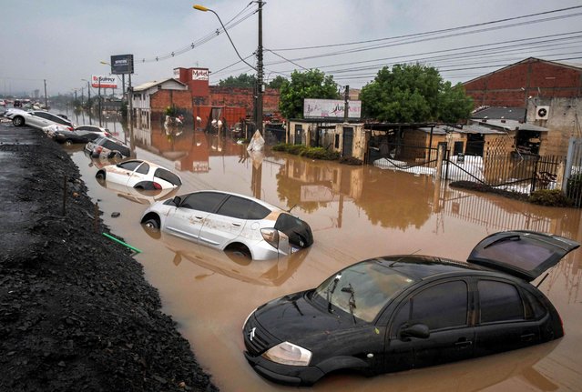 View of stranded cars along the BR-116 road in Sao Leopoldo, Rio Grande do Sul, Brazil, on May 12, 2024. New rains in waterlogged southern Brazil are expected to be heaviest between Sunday and Monday, authorities have warned, bringing fresh misery to victims of flooding that has killed 136 people and left 806 injured and 125 missing so far. (Photo by Nelson Almeida/AFP Photo)