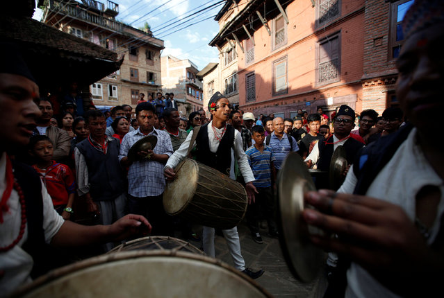 Devotees play traditional musical instruments as they take part for the sacrificial ceremony during “Dashain”, Hinduism's biggest religious festival in Bhaktapur, Nepal October 10, 2016. (Photo by Navesh Chitrakar/Reuters)