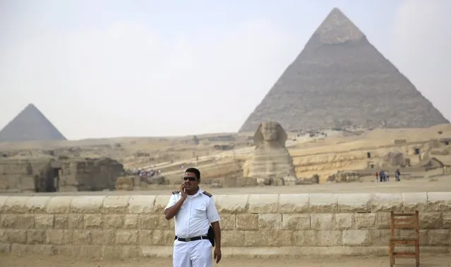 A policeman stands guard in front of the Sphinx at the Giza Pyramids on the outskirts of Cairo, Egypt, November 8, 2015. (Photo by Amr Abdallah Dalsh/Reuters)