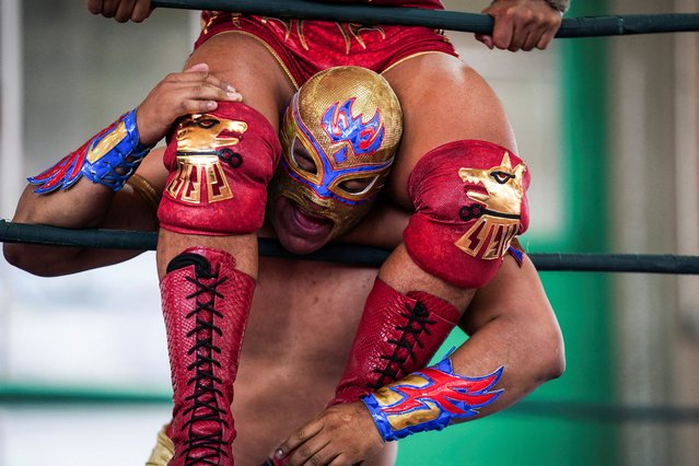 Wrestlers engage in a “Lucha Libre” performance to raise awareness for climate change in the Iztapalapa neighborhood in Mexico City on June 9, 2024. (Photo by Toya Sarno Jordan/Reuters)