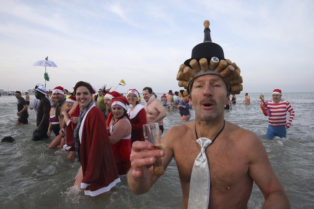 People wearing costumes participate in a traditional New Year's Day swim in Malo-les-Bains, northern France January 1, 2015. (Photo by Pascal Rossignol/Reuters)