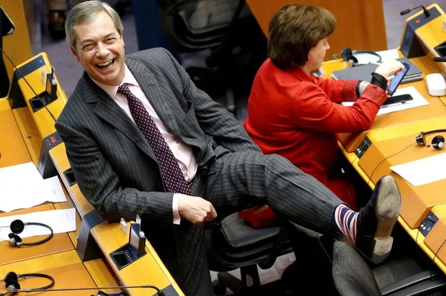 Brexit Party leader Nigel Farage smiles as he shows his socks during a plenary session at the European Parliament in Brussels, Belgium on January 29, 2020. The European Parliament gave final approval to Britain's divorce from the European Union, paving the way for the country to quit the bloc on Friday after nearly half a century and delivering a major setback for European integration. (Photo by Francois Lenoir/Reuters)