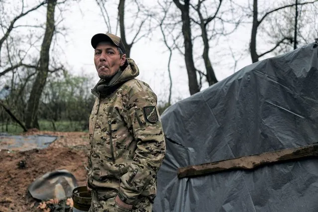 A Ukrainian soldier looks on at his position on the frontline in Bakhmut, Donetsk region, Ukraine, Thursday, April 13, 2023. (Photo by Libkos/AP Photo)