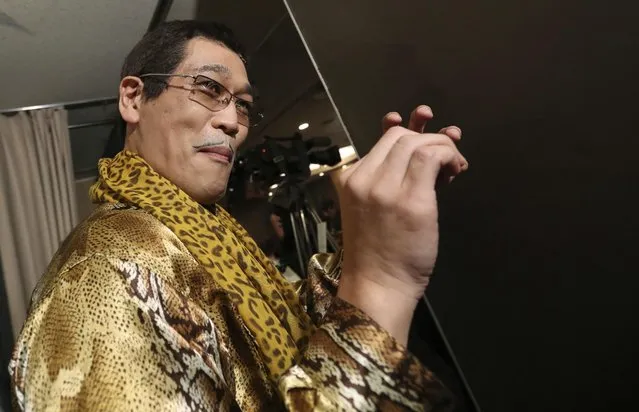 Japanese comedian Pikotaro, as he is known, gestures as he performs his viral hit “pen-pineapple-apple-pen” or “PPAP” during a press conference in Tokyo, Friday, October 28, 2016. Pikotaro says he is astonished by the global success of his PPAP song. It has more than 65 million YouTube views and was the first Japanese song in the U.S. Billboard top 100 singles in 26 years. (Photo by Eugene Hoshiko/AP Photo)