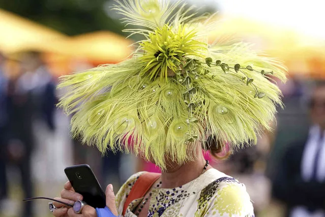 A racegoers sports a large hat on day three of the Qatar Goodwood Festival 2022 at Goodwood Racecourse, Chichester, England, Thursday July 28, 2022. (Photo by Adam Davy/PA Wire via AP Photo)