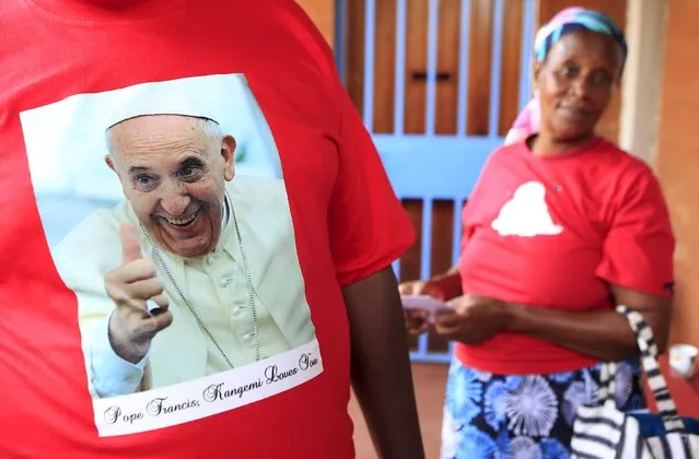 A man wearing a T-shirt with the picture of Pope Francis ahead of his visit to the St. Joseph the Worker Catholic Parish in Kangemi slums in Kenya's capital Nairobi November 24, 2015. (Photo by Noor Khamis/Reuters)