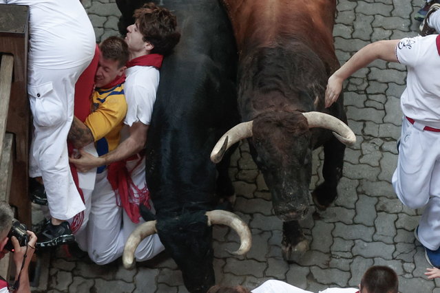 Several “mozos” or runners are chased by bulls, of Herederos de D. Jose Cebada Gago ranch, during the second “encierro” or running of the bulls of the San Fermin festival (locally known as “Sanfermines'” in Pamplona, northern Spain, 08 July 2024. The San Fermin festival 2024 runs from 06 to 14 July, with the running of the bulls as the main events. (Photo by Jesus Diges/EPA)