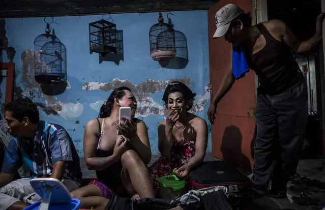 Transvestites prepare backstage before performing a traditional dance opera known as Ludruk on October 30, 2016 in Surabaya, Indonesia. Indonesia's LGBT community has been under a wave of attacks since the beginning of 2016 while the country's ministers had described transgenderism as a mental disorder, and gay s*x had been criminalized, as well as nonmarital heterosexual s*x. In Mojokerto, a traditional dance opera group called Ludruk Karya Budaya continues to be an art form, performed by transvestites who play female roles while adding a touch of comedy. Consisting of 18 transgenders in group, each of them earn up to Rp 150,000 ($15USD) per show since the act began May 29, 1969 in Mojokerto, East Java. Homosexuality and gay s*x are not illegal in Indonesia but the world's largest Muslim country has been increasing meeting intolerance from the Indonesian public. (Photo by Ulet Ifansasti/Getty Images)
