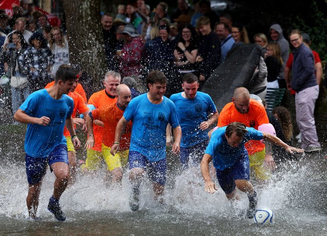 People compete in the annual football match in the River Windrush in Bourton-on-the-Water, Gloucestershire, Britain, on August 26, 2024. (Photo by Lee Smith/Reuters)