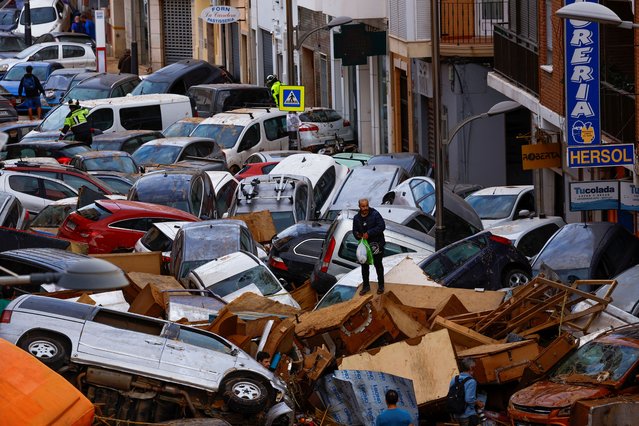 A man stands next to stranded cars, following floods in Sedavi, Valencia, Spain on October 31, 2024. (Photo by Susana Vera/Reuters)