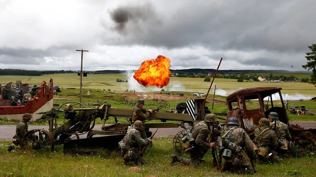Military enthusiasts take part in a re-enactment of a World War II battle on the eve of Independence Day at the “Stalin Line” memorial near the village of Goroshki, Belarus July 2, 2018. (Photo by Vasily Fedosenko/Reuters)
