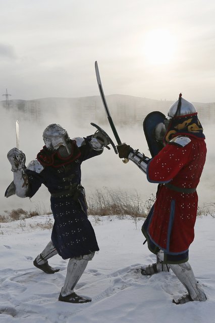 Members of the “Avalon” team wearing 14th century knight costumes fight against each other on the bank of the Yenisei River during the regional amateurs tournament of clubs of historical reconstruction, “The Battle of the Nations 2015. Siberia”, in Krasnoyarsk January 24, 2015. (Photo by Ilya Naymushin/Reuters)