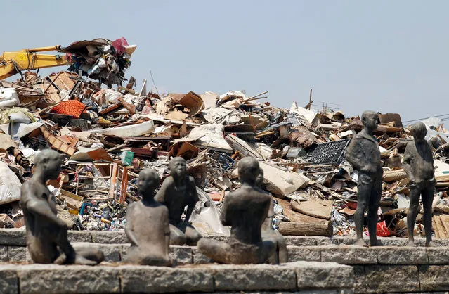 Household waste, caused by a flooding, are piled up at a temporary waste-collection point in Kurashiki, Okayama Prefecture, Japan, July 14, 2018. (Photo by Issei Kato/Reuters)
