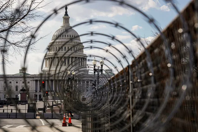 The U.S. Capitol is seen through razor wire after police warned that a militia group might try to attack the U.S. Capitol in Washington, U.S., March 4, 2021. (Photo by Joshua Roberts/Reuters)