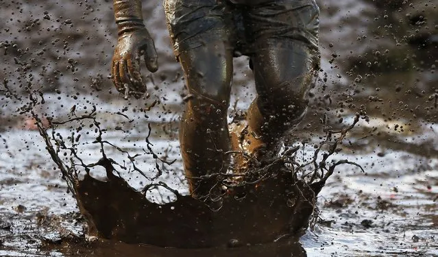 A competitor runs through mud during the Tough Guy event in Perton, central England, February 1, 2015. (Photo by Phil Noble/Reuters)