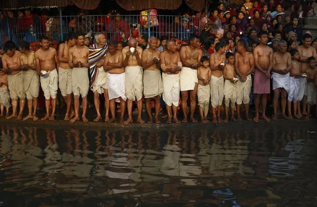 Devotees offer prayer as they stand on the bank of the Hanumante River, during the final day of the month-long Swasthani festival, at Bhaktapur, near Kathmandu, February 3, 2015. (Photo by Navesh Chitrakar/Reuters)