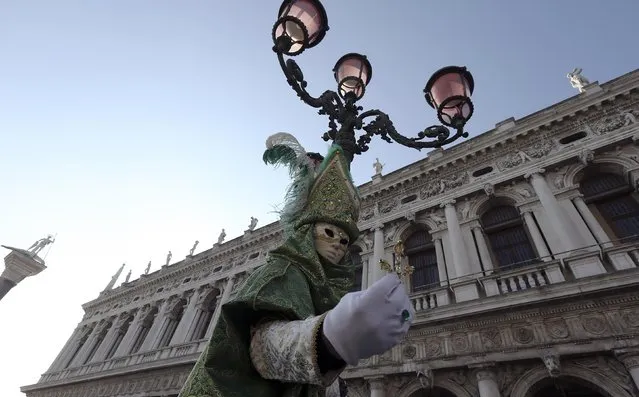 A masked reveller poses at Saint Mark's square during Carnival in Venice, February 8, 2015. (Photo by Stefano Rellandini/Reuters)