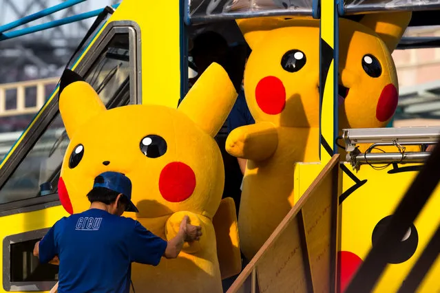 Performers dressed as Pikachu, a character from Pokemon series game titles, disembark an amphibious bus during the Pikachu Outbreak event hosted by The Pokemon Co. on August 10, 2018 in Yokohama, Kanagawa, Japan. (Photo by Tomohiro Ohsumi/Getty Images)