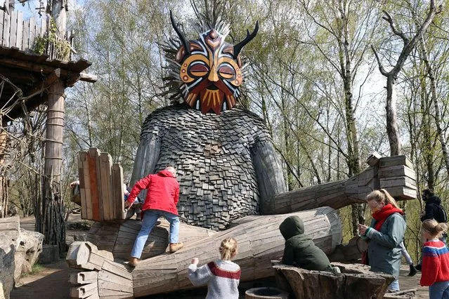 Giant wooden sculptures crafted by recycling artist Thomas Dambo are seen in De Schorre park in Boom, Belgium on April 9, 2021. Using old pallets, recycled wood, broken branches and fallen trees, Dambo builds the wooden sculptures to celebrate the 15th anniversary of an electronic music festival. The sculptures range from 7 to 18 meters long and it took around 25 weeks to build them. The various wooden figures can be found dotted throughout the forest in Boom town. (Photo by Dursun Aydemir/Anadolu Agency via Getty Images)
