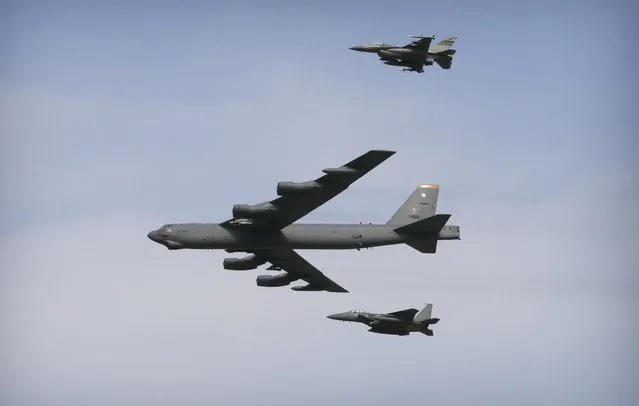A U.S. Air Force B-52 bomber flies over Osan Air Base in Pyeongtaek, South Korea, Sunday, January 10, 2016. The powerful U.S. B-52 bomber flew low over South Korea on Sunday, a clear show of force from the United States as a Cold War-style standoff deepened between its ally Seoul and North Korea following Pyongyang's fourth nuclear test. (Photo by Ahn Young-joon/AP Photo)
