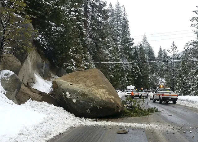 This photo released by the California Department of Transportation shows a boulder that fell onto a lane of Highway 50 near Kyburz, Calif., Wednesday, January 13, 2016. The heavy rain that poured over the San Francisco Bay Area early Wednesday morning moved east toward the Sierra where a good foot of snow was set to blanket mountain passes. Travelers were warned to expect delays and poor visibility for the passes over Interstate 80 and Highway 50. (Photo by California Department of Transportation via AP Photo)