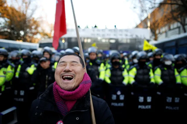 A man chants slogans in front of riot policemen who block a road leading to the Presidential Blue House during a protest calling for South Korean President Park Geun-hye to step down in central Seoul, South Korea, December 10, 2016. (Photo by Kim Hong-Ji/Reuters)