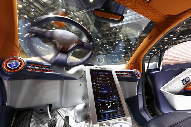 The steering wheel movement is seen inside a Rinspeed Budii self-driving electric city car during the second press day ahead of the 85th International Motor Show in Geneva March 4, 2015. Mounted on a swivelling motorised arm the steering wheel can be used to drive from either side of the car. When not in use the steering wheel rests in the middle of the dashboard.  REUTERS