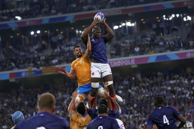 France's Sekou Macalou, top, catches the ball during the Rugby World Cup Pool A match between France and Uruguay at the Pierre Mauroy stadium in Villeneuve-d'Ascq, near Lille, France, Thursday, September 14, 2023. (Photo by Thibault Camus/AP Photo)