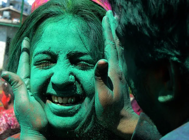 Members of the Nepalese ethnic Madhesi community daub each other's faces with coloured powders during Holi festival celebrations in Kathmandu on March 6, 2015. The Holi festival of colours is a riotous celebration of the coming of spring and falls on the day of the full moon in March every year. AFP PHOTO / PRAKASH MATHEMA        (PRAKASH MATHEMA/AFP/Getty Images)