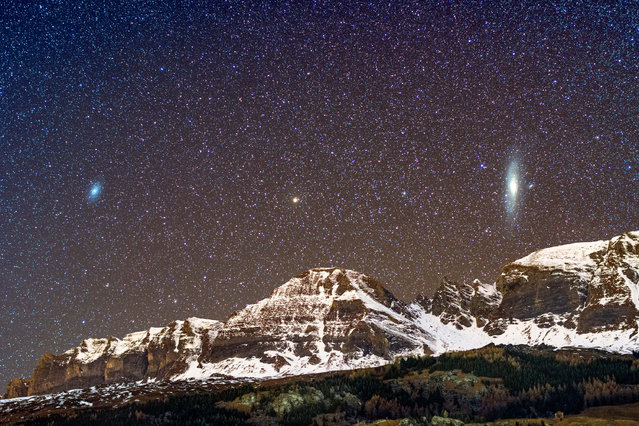 A view of the Triangulaum and the Andromeda Galaxy above a mountain. (Photo by Sandro Casutt/Caters News)