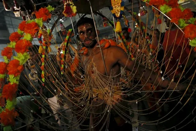 A devotee dances in his kavadi during Thaipusam festival in Singapore January 24, 2016. Thaipusam is a Hindu festival observed on the day of the full moon during the Tamil calendar month of Thai, and celebrated in honour of the Hindu god Lord Murugan. (Photo by Edgar Su/Reuters)