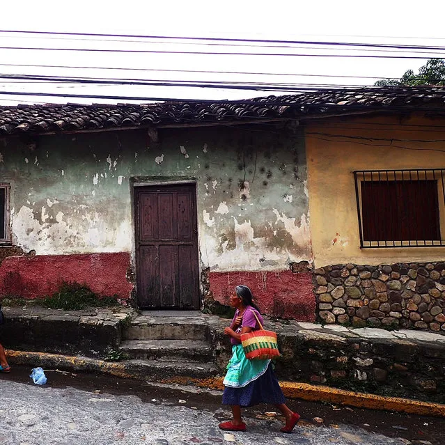 “I spotted this Mayan woman walking home up the hill with her shopping in Honduras. I felt the backdrop of the houses and colours captured the essence of the town”. (Photo by Claire Majury/Guardian Witness)