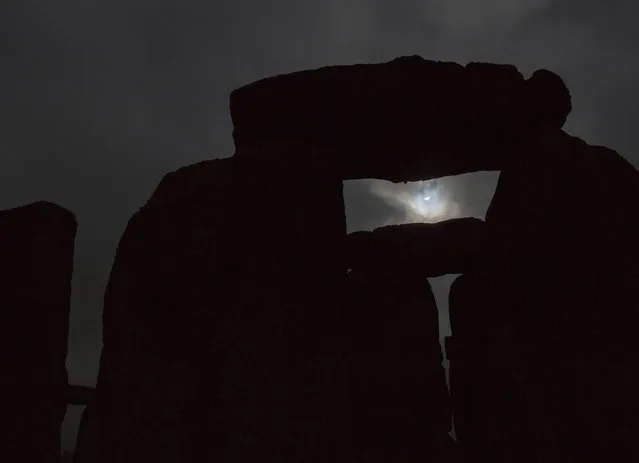 The solar eclipse is seen over Stonehenge on Salisbury Plain, Salisbury, southern England March 20, 2015. (Photo by Kieran Doherty/Reuters)