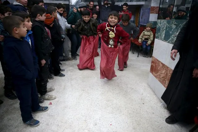 Orphans take part in a sack race during a gathering organized by Damascus Lovers, a group that helps with social support for orphans, in Harasta, in the eastern Damascus suburb of Ghouta, Syria January 30, 2016. (Photo by Bassam Khabieh/Reuters)