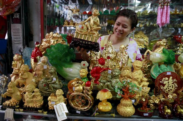 A woman arranges monkey figurines on display at a store in Chinatown, Binondo, metro Manila February 1, 2016, as Chinese New Year nears. (Photo by Romeo Ranoco/Reuters)