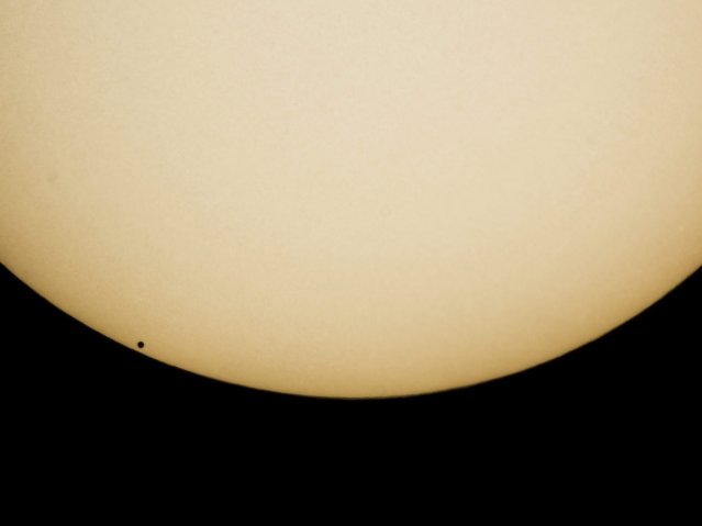 The transit of Mercury (L, bottom) in front of the Sun is seen from Salgotarjan, 109 kilometers northeast of Budapest, Hungary, 09 May 2016. A transit of Mercury across the Sun takes place when the planet comes between the Sun and the Earth, and Mercury is seen as a small black dot moving across the face of the Sun. (Photo by Peter Komka/EPA)