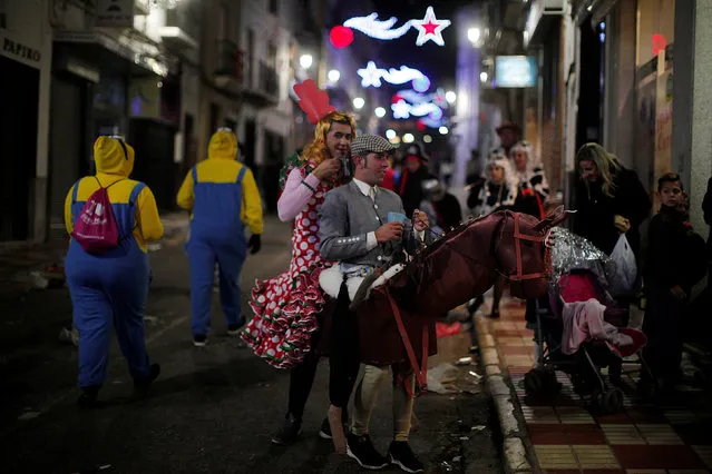 Revellers dressed up as an Andalusian horseman and a woman wearing a traditional Sevillana dress take part in New Year celebrations in Coin, near Malaga, southern Spain, January 1, 2017. (Photo by Jon Nazca/Reuters)