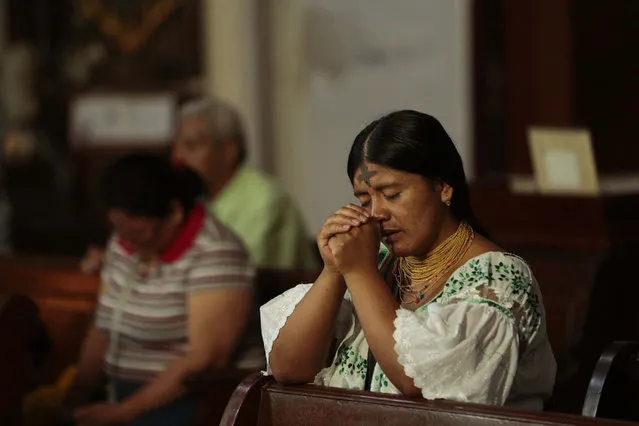 A woman prays during Ash Wednesday mass at the La Merced church in Panama City, Wednesday, February 10, 2016. Ash Wednesday for Catholics worldwide ushers in a period of penitence and reflection, known as the season of Lent, that leads up to Easter Sunday. (Photo by Arnulfo Franco/AP Photo)