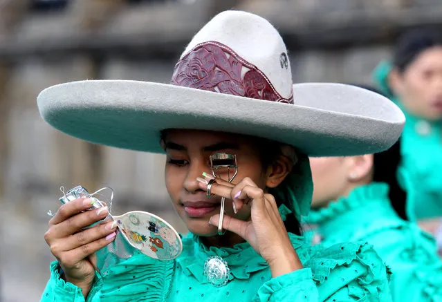 A woman dressed like a Escaramuza charra (traditional cowgirl) prepares to parade on the “International Day of Charro and Charrería” in Guadalajara, state of Jalisco, Mexico on September 14, 2022. The Mexican charrería was declared in 2016 Intangible Cultural Heritage of Humanity by Unesco. (Photo by Ulises Ruiz/AFP Photo)
