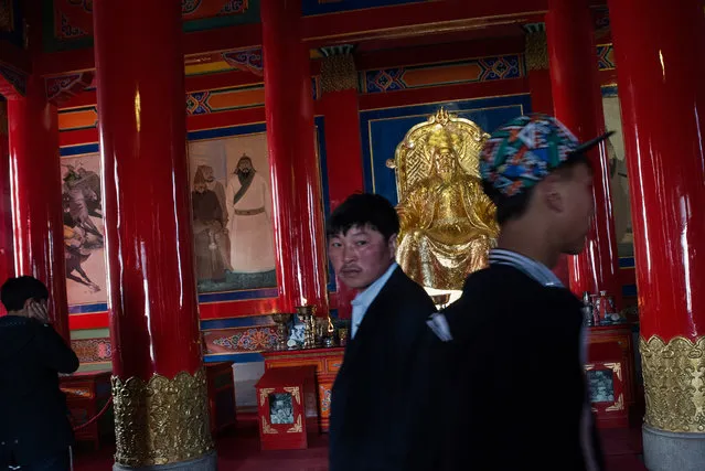 Visitors at a temple dedicated to Genghis Khan in Ulan Hot. (Photo by Gilles Sabrie/The Washington Post)