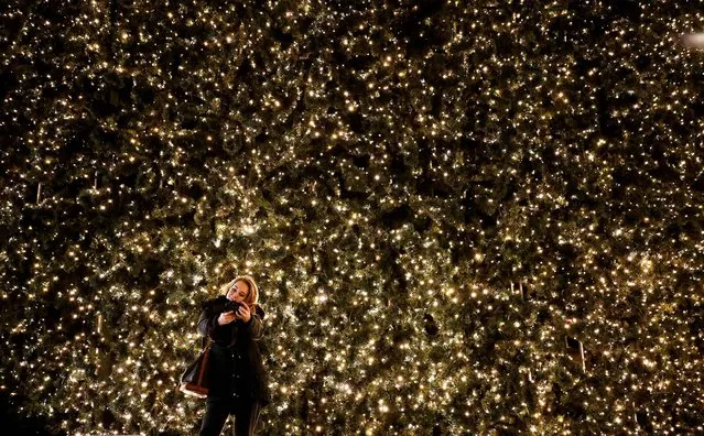 A woman takes a picture of herself with part of the Christmas illumination at a shopping mall in Berlin. (Photo by Fabrizio Bensch/Reuters)