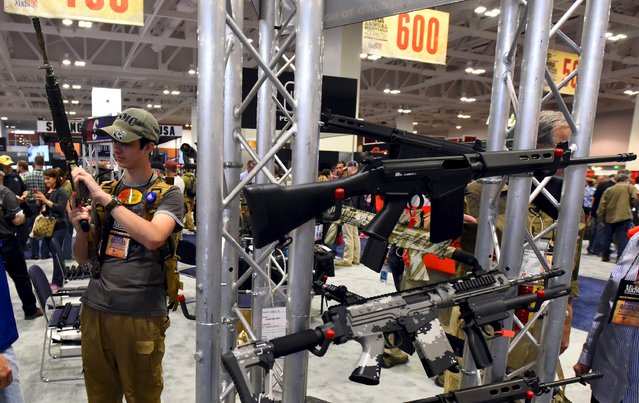 Attendees visit the trade booths during the National Rifle Association's annual meeting in Nashville, Tennessee April 11, 2015. (Photo by Harrison McClary/Reuters)