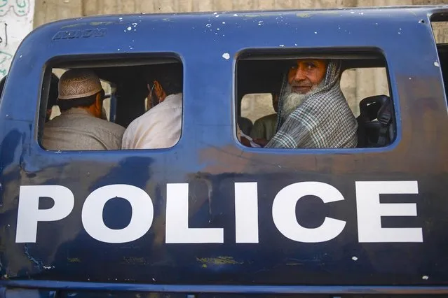 Detained Afghan refugees sit in a van during a search operation to identify alleged illegal immigrants, on the outskirts of Karachi on November 17, 2023. More than 200,000 people have crossed from Pakistan into Afghanistan, Pakistani border officials said, the vast majority since an October ultimatum given to the 1.7 million Afghans Islamabad said were living illegally in the country. (Photo by Asif Hassan/AFP Photo)