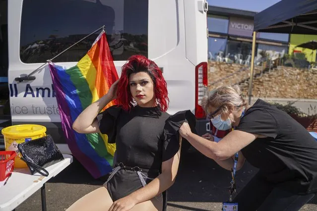 17-year old Ben Kitts (aka missamyross) receives a Covid vaccination from the NHS during the first day of the Cornwall Pride LGBTQ festival on August 27, 2021 in Newquay, England. Cornwall Pride is taking place at a time when the town of Newquay has one of the highest Covid infection rates in the UK. The event organisers worked with the local council's public health advisers prior to the event to access it's impact before permitting it to go ahead with social distancing and mask-wearing requested even though the event is being hosted in the open air Killacourt park. (Photo by Hugh Hastings/Getty Images)