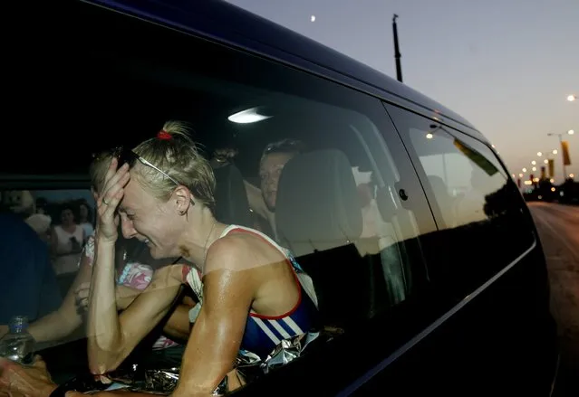 Britain's Paula Radcliffe cries in a vehicle after retiring from the women's marathon in the Athens 2004 Olympic Games in Greece August 22, 2004. (Photo by Yannis Behrakis/Reuters)